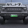 Silver Ford Bronco SUV With Large Off Road Tires And Modern Front Design