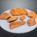 Brown Wooden Stone Pieces of Various Shapes Displayed on White Plate