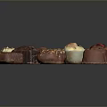 Assorted Chocolate Candies With Various Flavors Different Shapes And Decorative Toppings