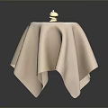 Modern Furniture Table With Beige Textured Tablecloth And Small Decorative Figurines