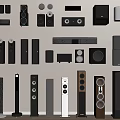 Diverse Collection of Headphones and Speakers Arranged on Wall and Floor