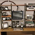 Vintage Daily Electrical Appliances Display on Wooden Shelves with Old TVs Radios and Computers