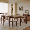 Elegant Dining Space With Wooden Table Chairs Vase Glassware Cabinet Artwork And Plant