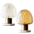 Modern Table Lamp With Transparent Glass Shade And Brass Base Illuminating Warm Light
