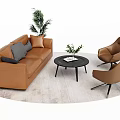 Brown Two Seater Sofa With Armchairs Coffee Table And Green Plants On Light Rug