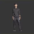Child Standing In Dark Hoodie And Dark Pants Against Grey Background