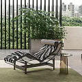 Zebra Pattern Lounge Chair With Small Side Table On Balcony City View And Green Rug