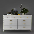 White Entryway Console Side Cabinet With Gold Handles Drawers And Decorative Globe Candles Plant Books