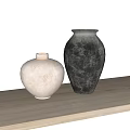 Textured Ceramic Vases In White And Dark Tones On Wooden Table
