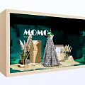MOCO Window Display Featuring Elegant Dress With Decorative Plants And Green Backdrop