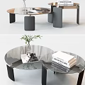 Modern Round Glass Top Coffee Table With Black Metal Legs And Decorative Books Vase