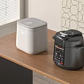 White Rice Cooker And Black Electric Pressure Cooker On Wooden Kitchen Counter With Geometric Wallpaper