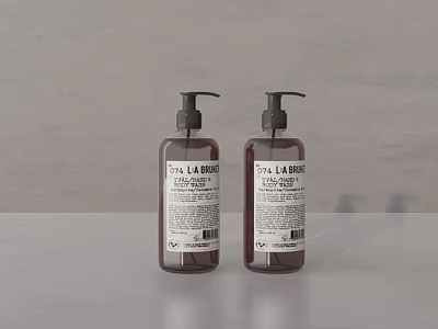 Two LA FABRIQUE Liquid Hand Soap Bottles On Grey Surface With Clean Design 3d model