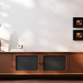 Wooden TV Stand With Drawers Glass Doors Yellow Sculpture White Cup Books Black Framed Paintings
