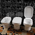 Three Modern Toilets with Black Marble Tile Wall and Colorful Patterned Floor
