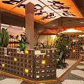 Modern Restaurant Interior With Unique Ceiling Design Green Plants And Cozy Seating Area
