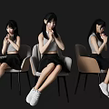 Three Women Sitting on Gray and Beige Chairs Wearing Gray Tops Black Skirts White Sneakers