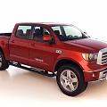 Red Toyota Tundra Crew Cab Pickup Truck With Chrome Grille And Alloy Wheels