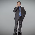 Businessman in Dark Suit and Blue Shirt Talking on Phone with Left Hand in Pocket Against Gray Background
