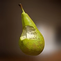 Fresh Green Pear With Bite Mark And Exposed Juicy Flesh On Blurred Background