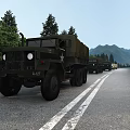 Military Trucks In A Convoy Driving On The Highway With Mountains And Trees