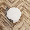 Modern White Round Bedside Table With Black Woven Accent And Herringbone Wooden Floor