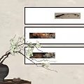 Three Framed Artworks on Gray Wall with Vase and White Flowers on Small Table