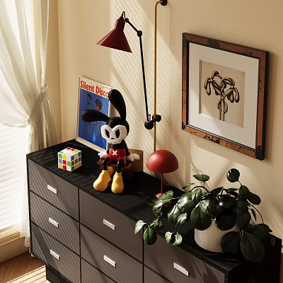 Black Dresser Topped With Mickey Mouse Plush Rubik's Cube Red Lamp And Green Plant 3d model