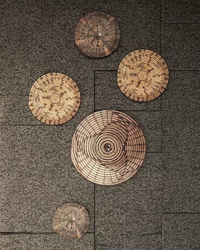 Woven Circular Wall Decor with Concentric Patterns on Gray Textured Wall 3d model