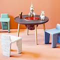 Kids Table with Green Blue White Chairs Pencils and Toys on Orange Background
