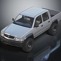 Toyota Silver Four Door Pickup Truck With Off Road Tires And Cab Bed