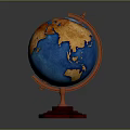 Decorative Desktop Globe With Red Stand Blue Oceans And Golden Continents On Gray Background
