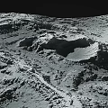 Lunar Landscape With Rugged Terrain Large Impact Craters And Gray Surface