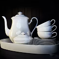 White Dinnerware Set with Pitchers Cups Plates Bowls and Glassware Displayed on Kitchen Shelves