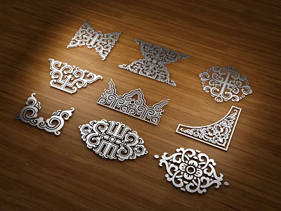 Intricate Carved Metal Ornaments With Various Decorative Patterns On Wooden Surface 3d model