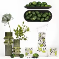 Fresh Green Limes on Black Plate with Vase Green Leaves and Pitcher with Ice