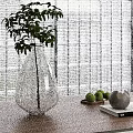 Transparent Teardrop Vase With Green Plant On Wooden Tabletop And Decorative Green Fruits Gray Spheres