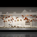 Contemporary Exhibition Installation With Suspended Metal Pieces Architectural Models And Text Elements