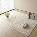 Beige Textured Square Rug with White Flower Vase and Magazine Basket on Wooden Floor