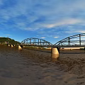 Steel Bridge Structure With Blue Sky People Walking And Road Surface Shadows