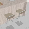 Modern Bar Stools With Beige Seats And Metal Frames Next To Light Colored Bar Counter