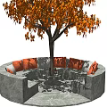 Circular Gray Outdoor Sofa With Orange Cushions Under Tree With Orange Leaves