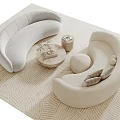 Modern Curved Light Sofa and Round Coffee Table Set with Decor Items on Textured Rug