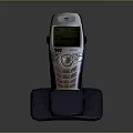 Vintage Mobile Phone On Charging Dock With Illuminated Screen And Classic Numeric Keypad