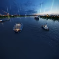 Night River Scenery With Several Boats On Calm Water And City Lights Illuminating Skyscrapers