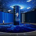 Blue Exhibition Hall with Central Cylindrical Pillar Characters People Walking and Ceiling Lighting Decorations