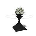 Round Coffee Table With Black Base And Vase With White And Green Flowers