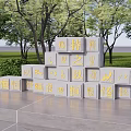 Garden Landscape With Trees Lawn Gray Blocks And Golden Characters On Platform