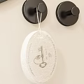 Black Circular Wall Hooks On Light Colored Wall With Hanging Tag Item