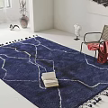 Blue Square Area Rug With White Line Patterns Tassels Open Book And Red Cloth Chair